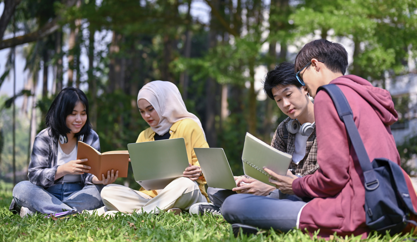 Students in a park studying. 