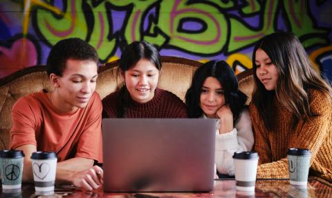 group of students in front of laptop