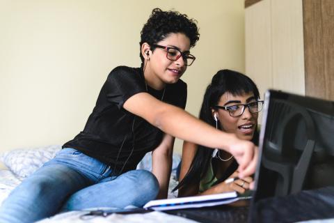 two students viewing computer in room